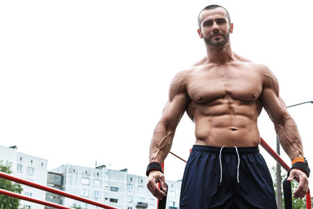 Muscular man posing on the street after his workout