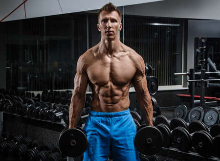 Muscular man in gym during workoutの写真素材