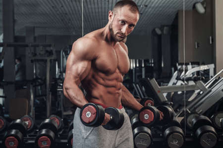 Young and muscular man doing a exercise for bicepsの写真素材
