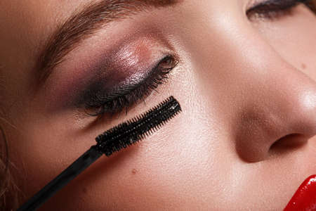 Close up of female face and mascara brushの写真素材