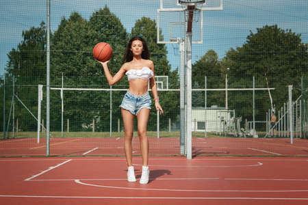 Sexy woman with on a  basketball playgroundの写真素材
