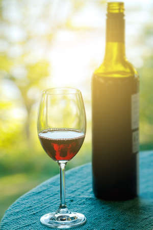 Glass of wine on the table with a bokeh on the backgroundの写真素材