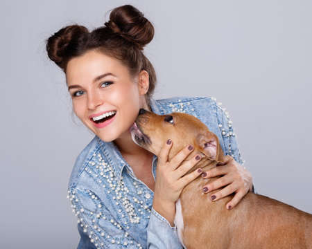 Happy woman and little staffordshire terrier puppyの写真素材