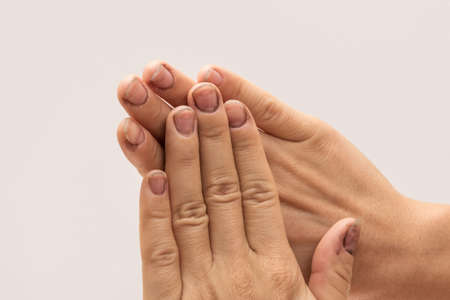 Female hands with dirty nails in studioの写真素材