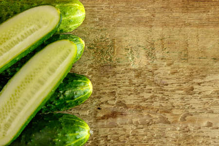 Fresh green cucumbers on wooden tableの写真素材