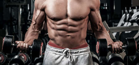 Young and muscular man doing a exercise for bicepsの写真素材