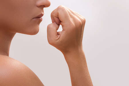 Close up of a female mouth biting her fingersの写真素材