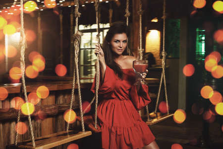 Charming woman in the stylish summer barの写真素材