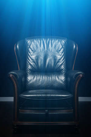 Leather armchair in dark roomの写真素材