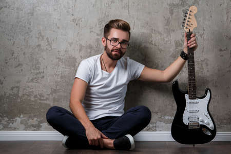 Stylish bearded  guy with a guitarの写真素材