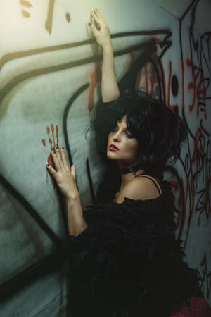 Strange and freaky woman in dark tunnelの写真素材