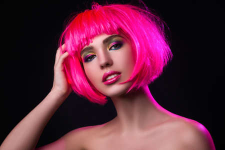 Potrait of young woman with pink hair in studioの写真素材