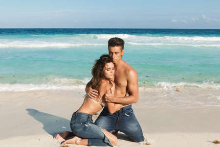 Beautiful couple in embrace on the beachの写真素材