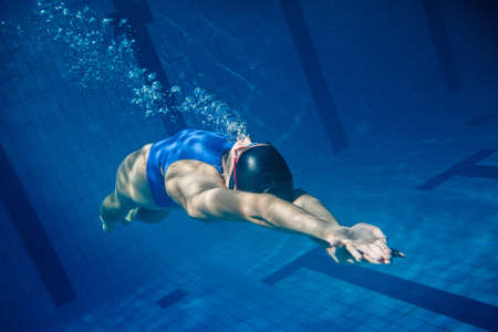 Swimmer woman underwater in the poolの写真素材