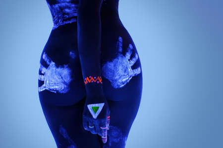 Female booty with traces of male hand in ultraviolet lightの写真素材