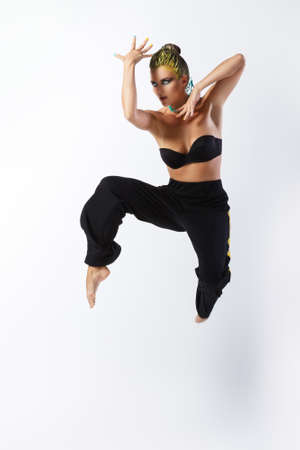 Stylish woman with yellow hair dancer in jumpの写真素材