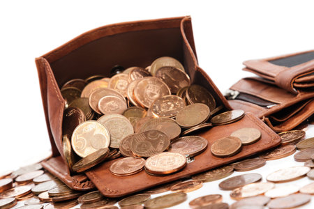 Leather wallet with a lot of euro cent coins on white background
