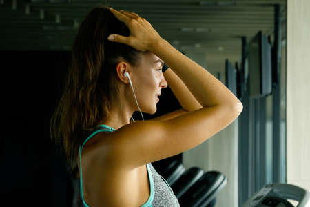 Sporty woman is listening music during her workoutの写真素材