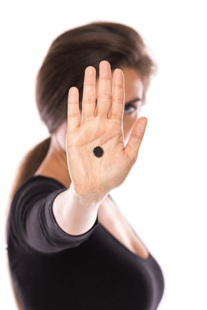 Woman with black dot on her palm give signal about domestic violence