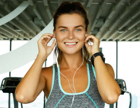 Sporty woman is listening music during her workoutの写真素材