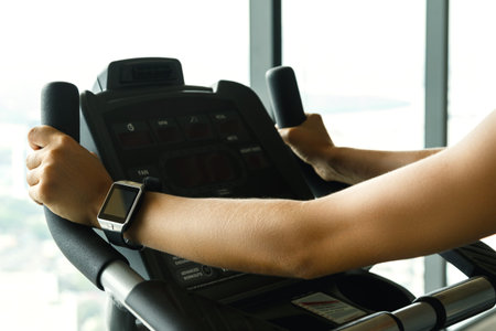 Close up of female hand with smart watches in the gym