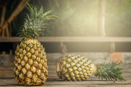 Pineapple fruits on wooden surfacee in the garden