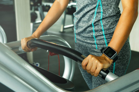 Close up of female hand with smart watches in the gym