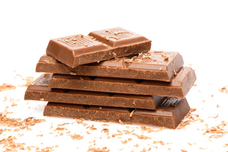 Pieces of milk chocolate on white backgroundの写真素材