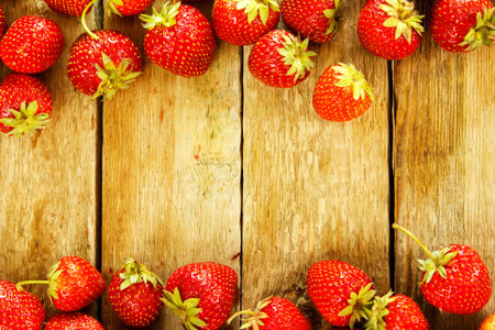 Fresh rustic strawberries on wooden tableの写真素材