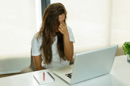 Overworked woman have headache in the office