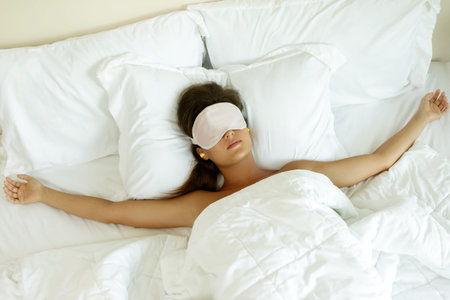 Woman is wearing eye mask and using earplugs for better sleeping