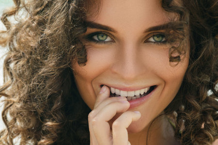 Portrait of beautiful woman with curly hair