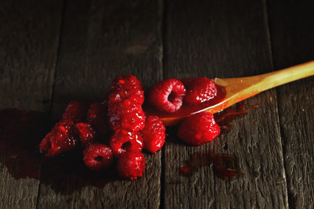 Raspberry jam and wooden spoon