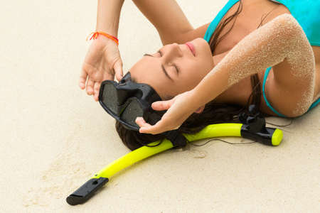 Young woman  with a mask for snorkeling. Summer and beach holidays.の写真素材