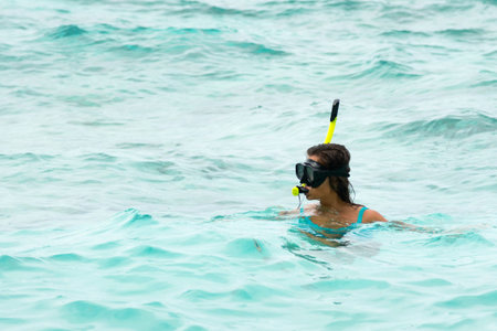 Woman swimming in the sea with a snorkeling mask