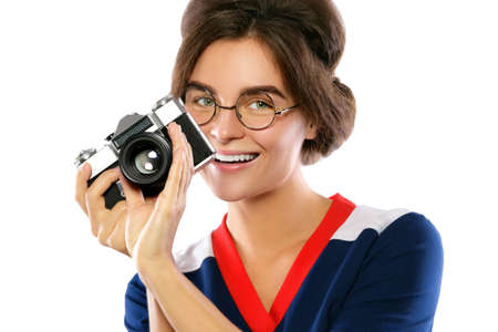 Woman model in vintage look holding retro camera in her hands isolated on white backgroundの写真素材