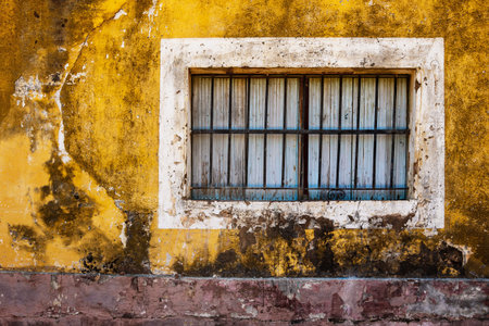 Old window and colorful grungy house