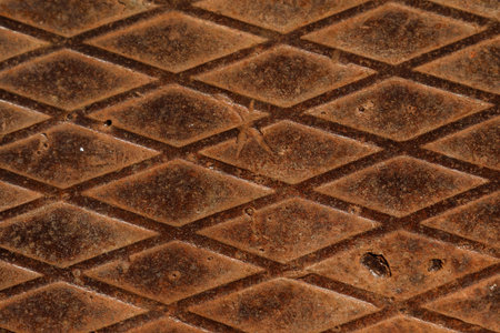Old rusty metal texture. Steel surface with rhombus pattern