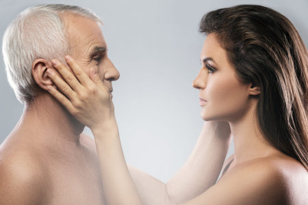Studio portrait of elderly father and his daughter