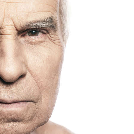 Part of old male face isolated on white backgroundの写真素材