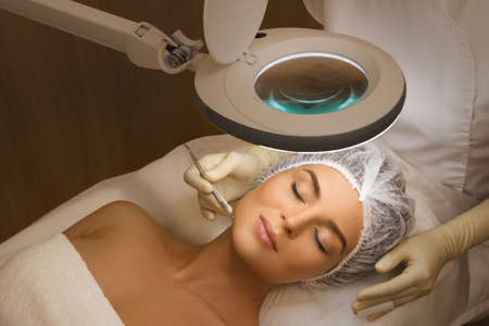 Woman in the professional beauty salon during a mechanical face cleansing procedureの写真素材