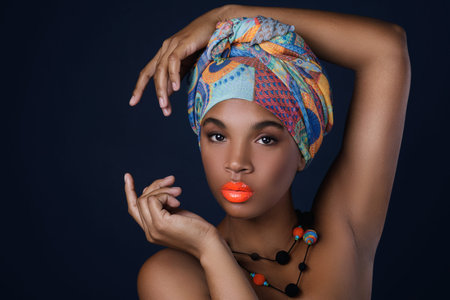 Portrait of African woman with a colorful shawl on her headの写真素材