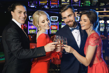 Group of happy people during celebration is drinking sparkling wine in the casino