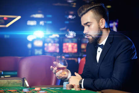 Rich handsome man playing roulette in the casinoの写真素材