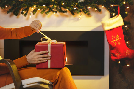 Woman opening Christmas gift in the red box
