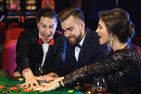 Group of young rich people playing roulette in the casino