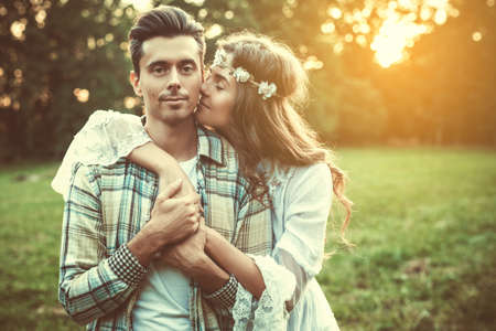 Outdoor portrait of young and beautiful couple at sunsetの写真素材