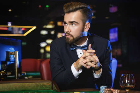 Rich handsome man playing roulette in the casinoの写真素材