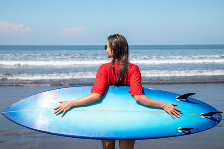Sexy woman surfer with shortboard on the beach