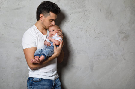 Young father kiss his cute little baby